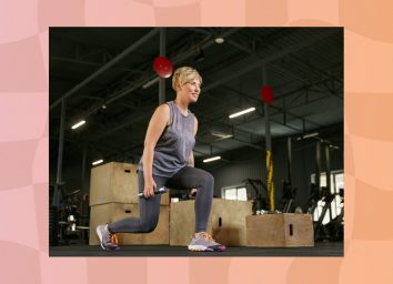 happy mature woman in gray tank top and dark gray leggings doing dumbbell lunges at the gym