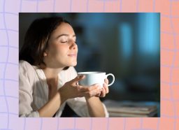 brunette woman holding cup of coffee at night