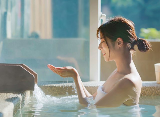 woman soaking in hot water therapy bath