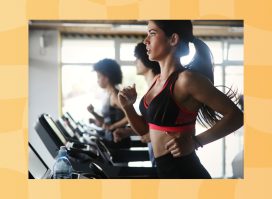 fit brunette woman running on treadmill at gym in line of treadmills