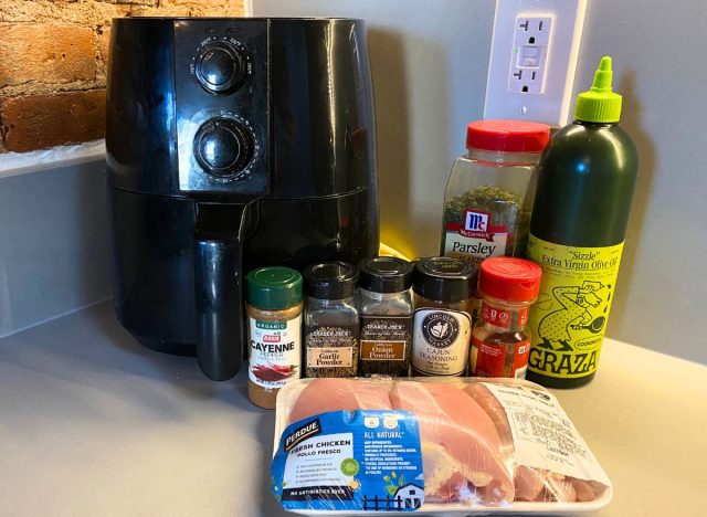 air fryer and ingredients for chicken thighs on kitchen counter