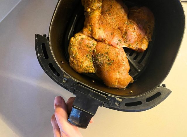 putting two chicken thighs in an air fryer