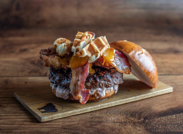 Kuma's Corner Sourvein Burger on wooden plank