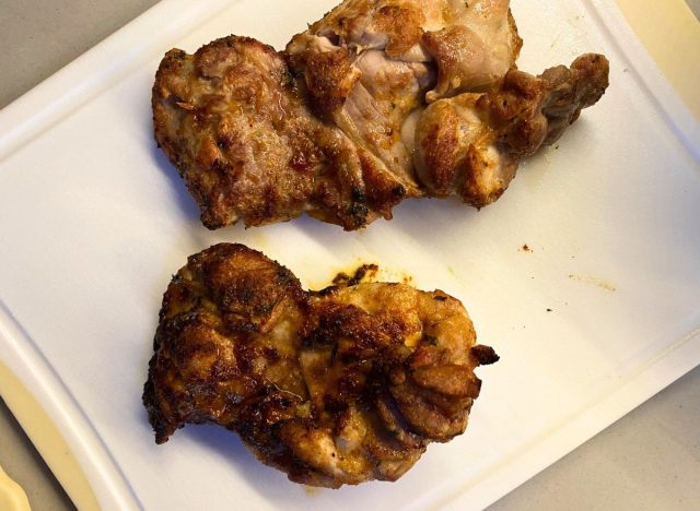 two air fryer chicken thighs on a cutting board