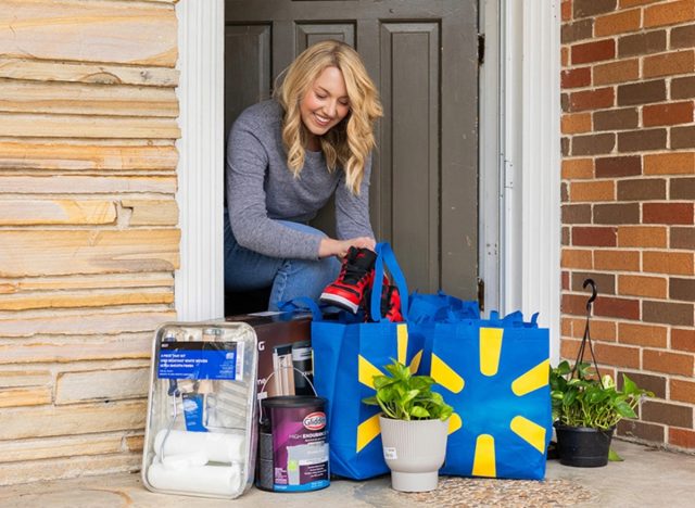 customer receiving walmart delivery order of multiple bags and products