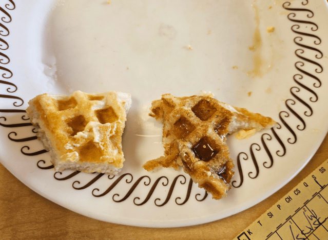 half eaten waffle on a plate 