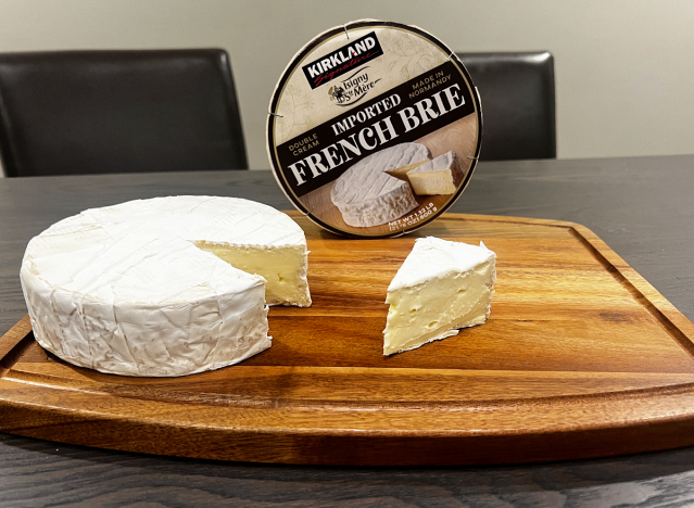 a wheel of brie cheese on a cutting board