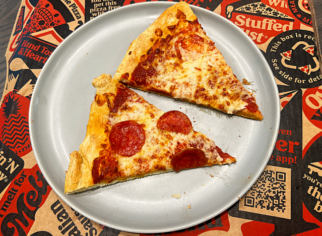 two slices of pizza hut pizza on a box