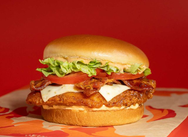 burger king's fiery royal crisy chicken sandwich on a red background