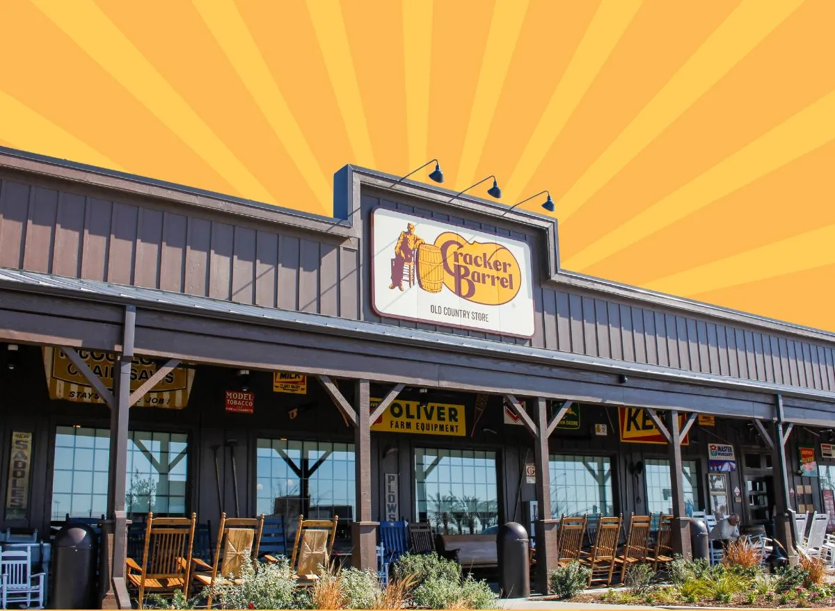 The storefront of a Cracker Barrel restaurant set against a vibrant gold and yellow background.