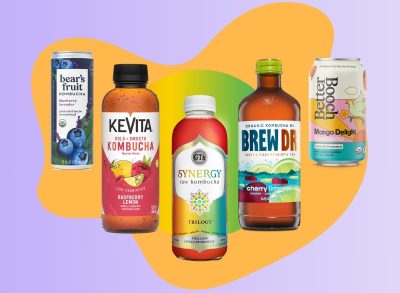 An array of bottled and canned kombucha beverages set against a colorful background