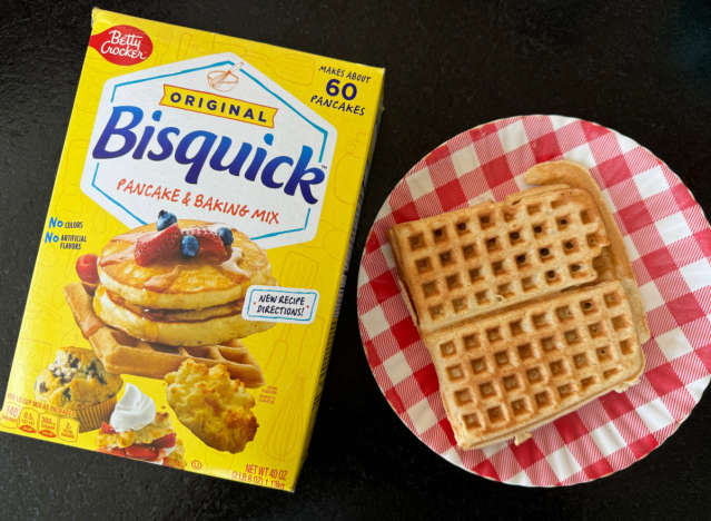 bisquick mix in a box next to a waffle on plate 