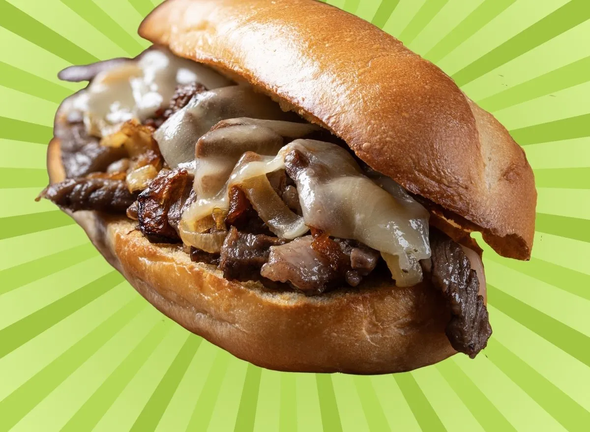 A classic cheesesteak sandwich on a graphic background