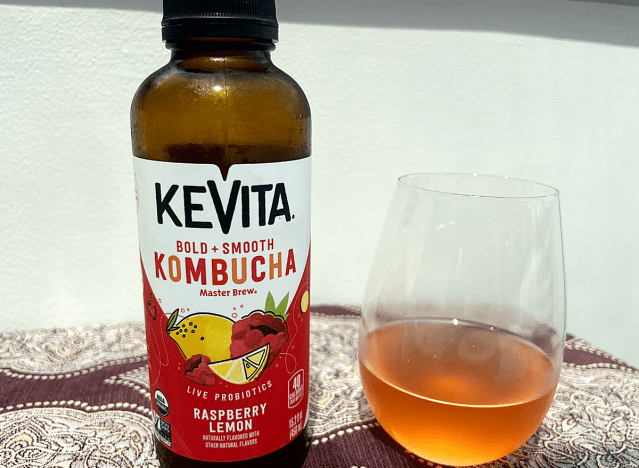 kevita kombucha bottle next to a glass of it