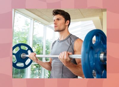 fit man doing barbell bicep curls at the gym