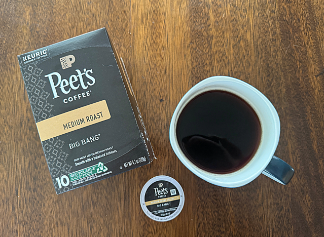 peets coffee k cup box next to a mug of coffee