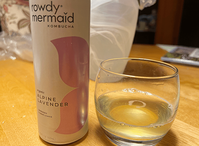 a can of rowdy mermaid kombucha next to a glass of it 