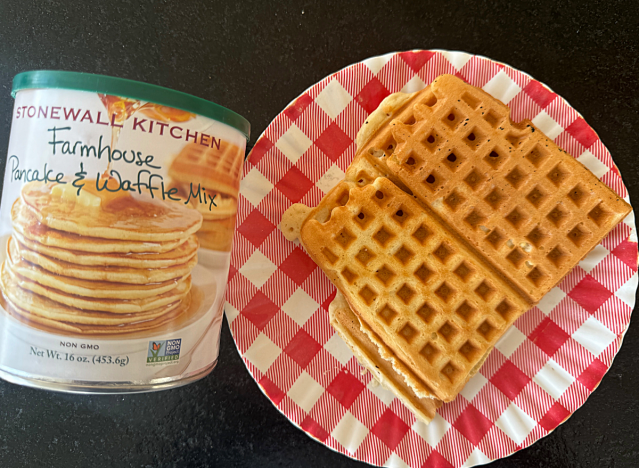 stonewall kitchen pancake mix next to waffles on a plate 