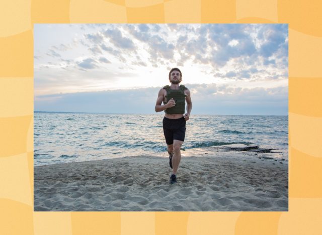 athlete training with a weighted vest on the beach