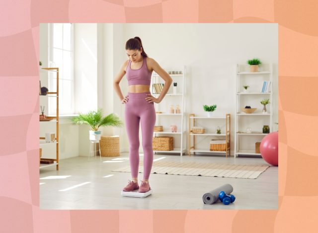 woman stepping on scale and looking at her weight