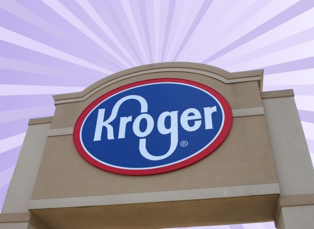 Signage bearing the red, white, and blue Kroger logo set against a virbant purple background