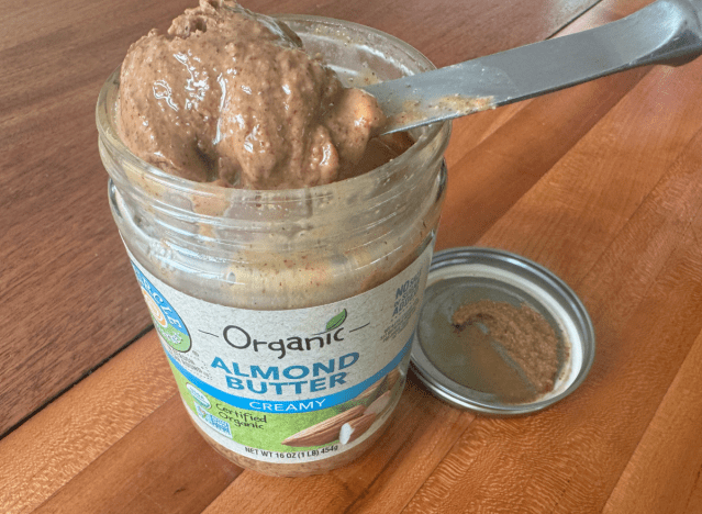 an open jar of full circle almond butter with a knife in it 
