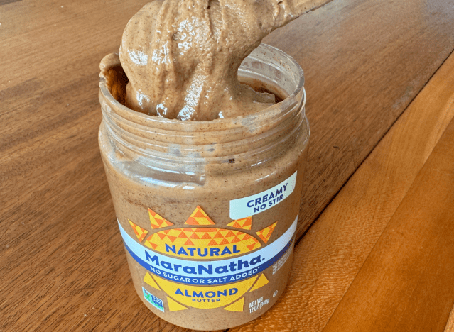 open jar of maranatha almond butter with knife in it