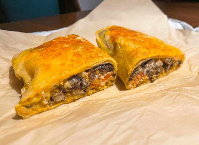 taco bell black bean grilled cheese burrito cut open on a wrapper