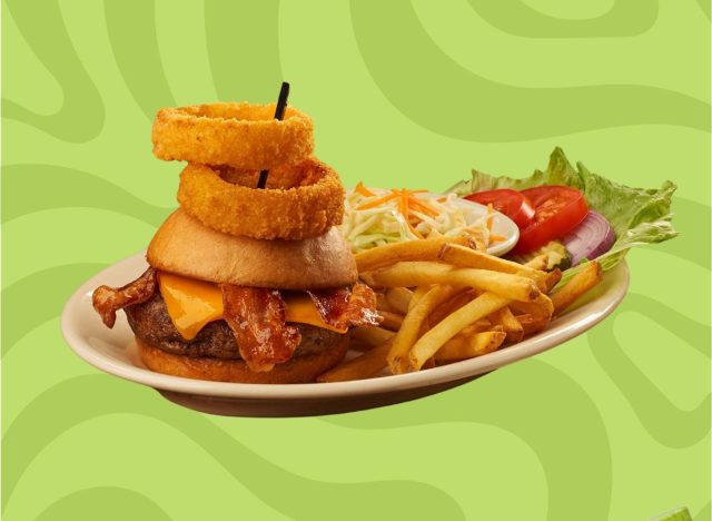 Black Angus Steakhouse Classic Burger with Onion Rings on a plate with fries