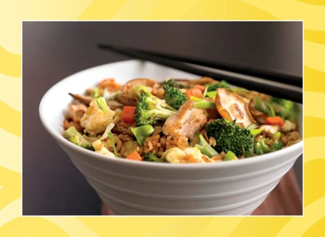 bowl of chicken fried rice on a yellow background