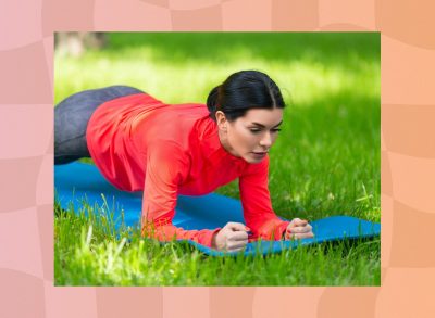 fit, focused brunette woman holding a forearm plank on a yoga mat on the lawn