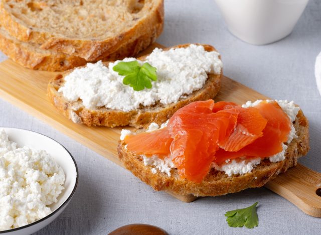 Sandwich with salted salmon and cream cheese on rustic background