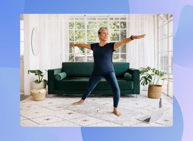 fit, mature woman doing yoga exercise in bright living space