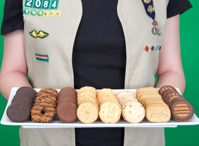 Cadette Girl Scout holding plate of Girl Scout cookies