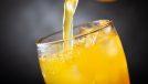 soft drink, pouring orange soda into glass on dark background