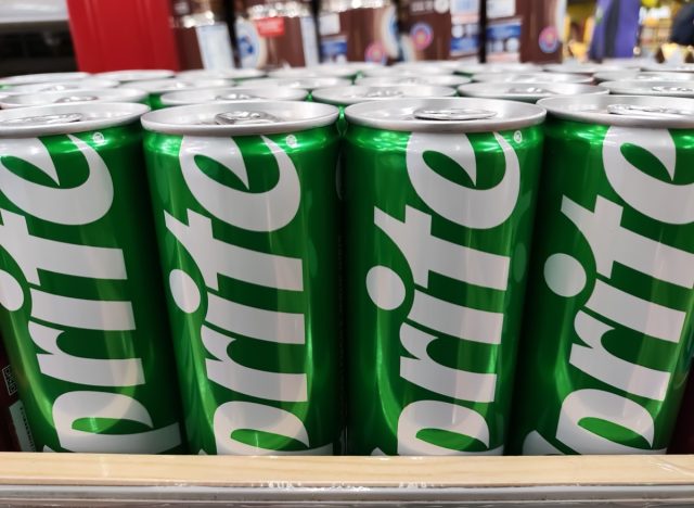 Malang, Indonesia 04-07-2024 : Sprite can in the supermarket. Sprite green can packaging design isolated on supermarket row shelf display background.
