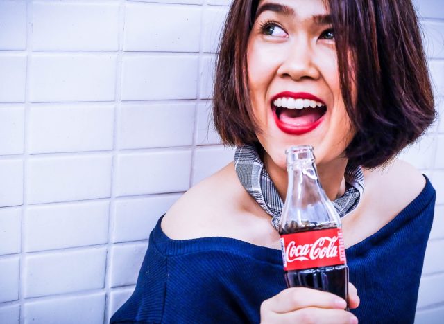 Woman with a bottle of Coca-Cola