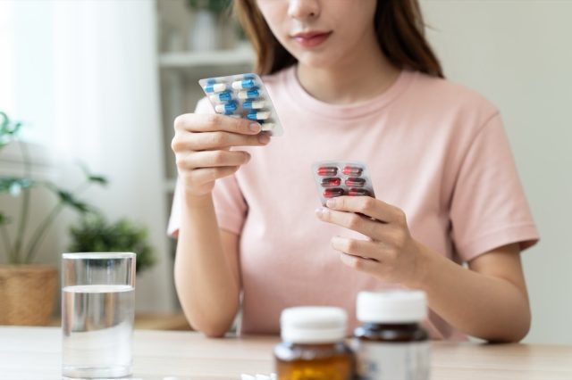 Healthcare Harmony: Close-Up Hands Holding Medication and Water Glass for Optimal Wellness, Pharmaceutical Treatment and mental health treatment