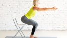Yoga with a chair. Fit adult caucasian woman practice squat with props on a mat in loft white studio indoor, selective focus. Fitness, workout, trainer, sport, healthy lifestyle, concept.