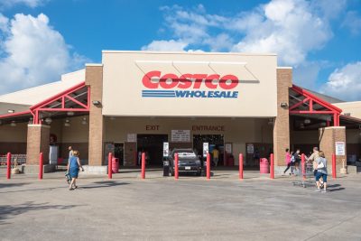 HOUSTON, TX, US-SEPT 16, 2017:Customers walk in with cart at Costco entrance. Costco Wholesale Corporation is largest membership-only warehouse club in US. It has total of 705 warehouses worldwide
