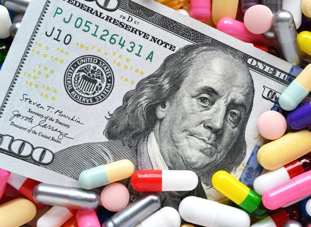 Pills on money dollars - Medicine prescription drugs cost concept - healthcare insurance expenses