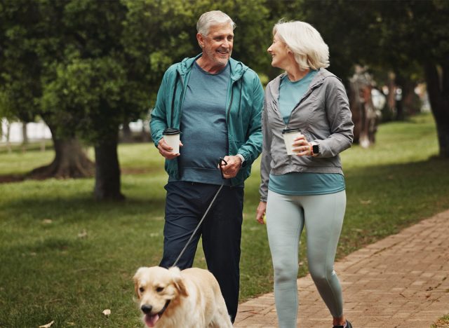 Senior couple walking their dog 