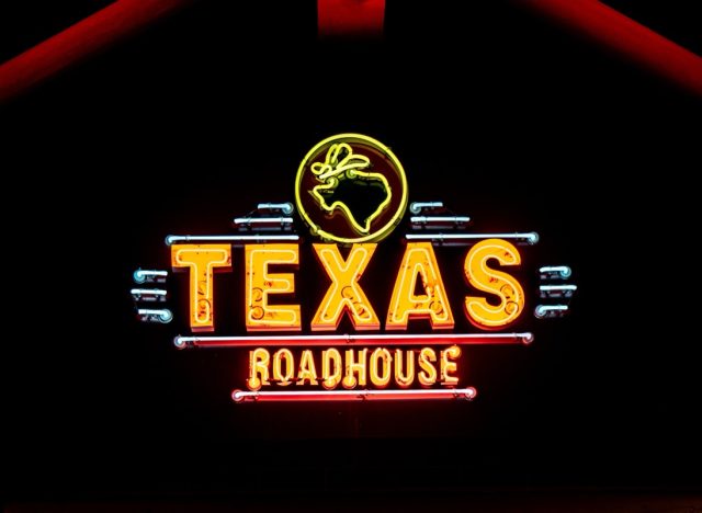 WOODBURY, MN, USA - DECEMBER 4, 2023: Texas Roadhouse restaurant exterior and trademark logo at night.