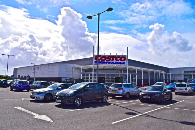 Cardiff, Cardiff County / Wales UK -4/25/2018:The modern Costco Wholesale Supermarket viewed from the busy car park at Capital Retail Park on a sunny day.