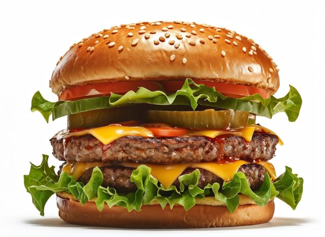 Close up of tasty burger isolated on white background. french fries and the burger with meat, cooking a burger at home. junk fast food.