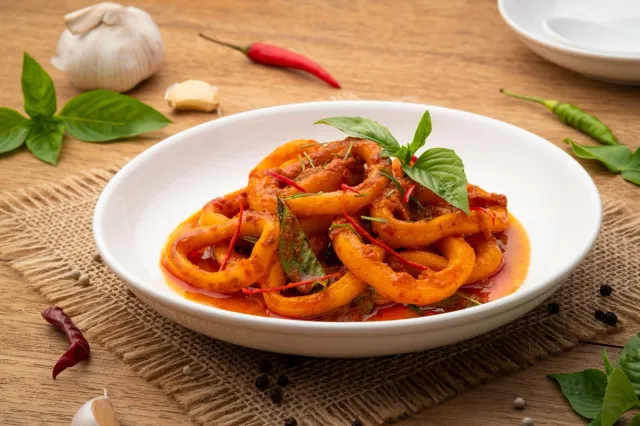 Stir-Fried Squid with Red Curry Paste in white plate.Thai spicy food