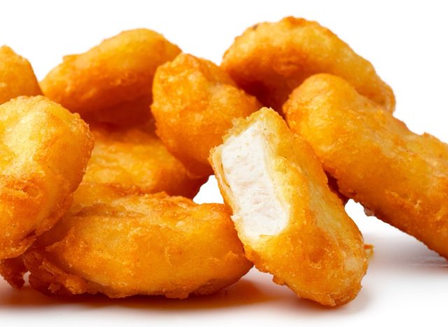 Pile of fried chicken nuggets isolated on white
