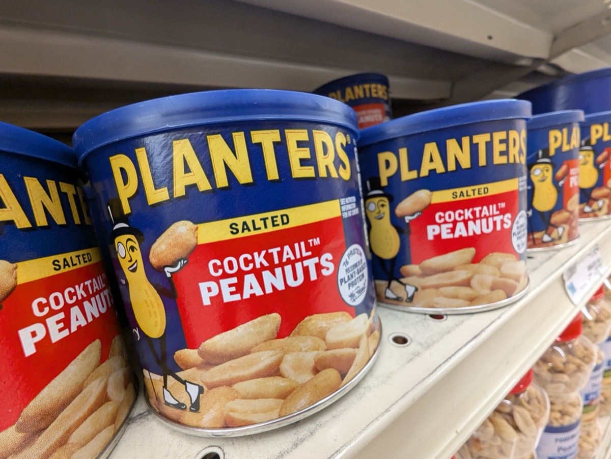 Apex, North Carolina - April 4 2025: Planters Salted Cocktail Peanuts Packages Mascot Mr Peanut Logo Display on Shelf at Food Lion
