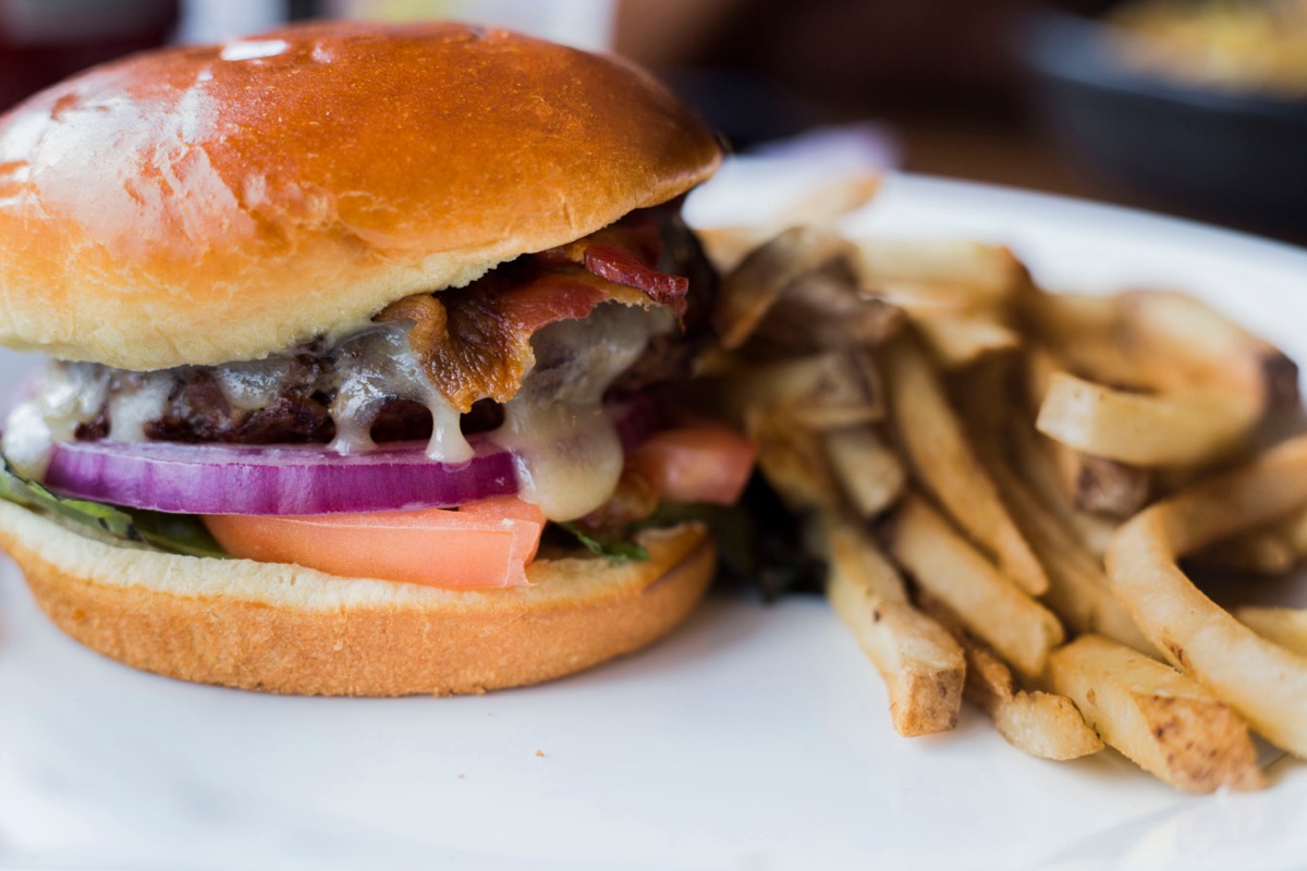 Burger and fries combo looking good on plate close up