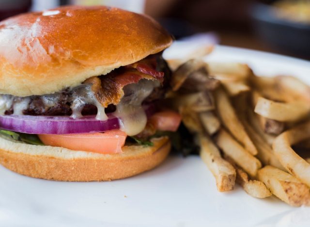 Burger and fries combo looking good on plate close up